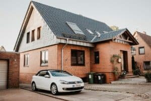 Red house with car for drive by inspections