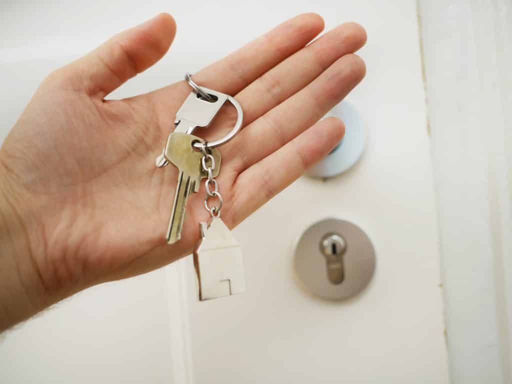 Hand holding keys to rental property