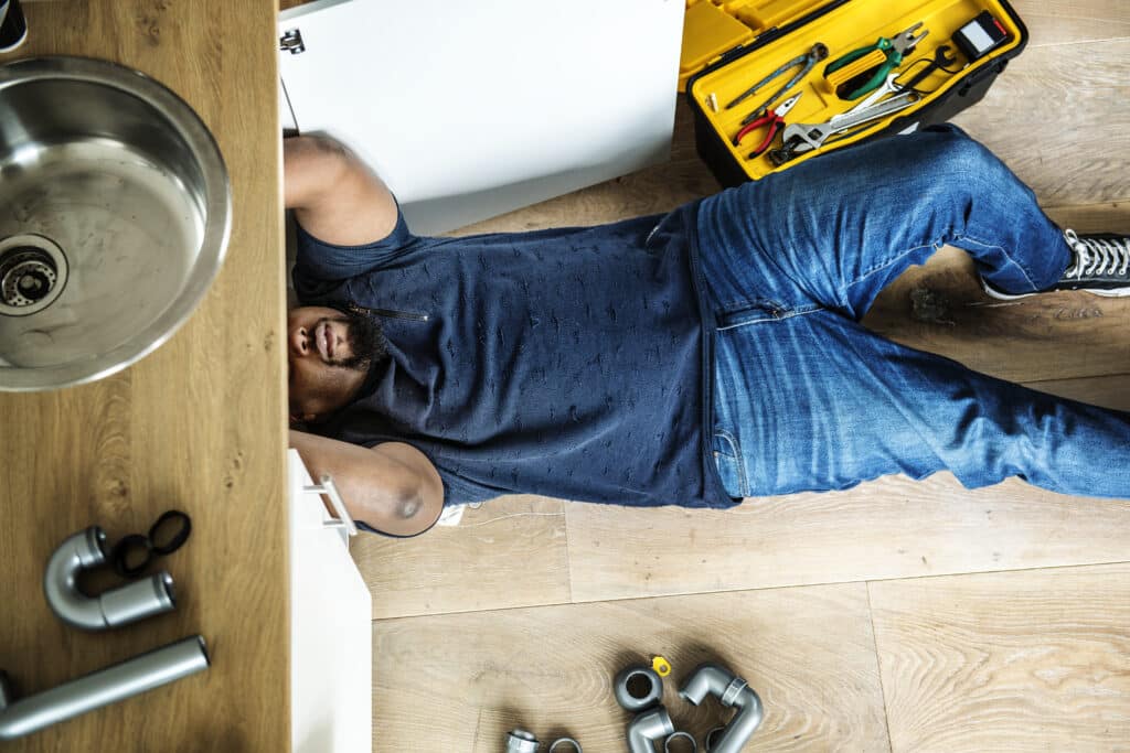 Homeowner fixing kitchen sink