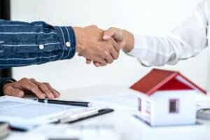 shaking hands over contract for house