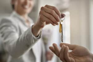 realtor delivering homeowners keys