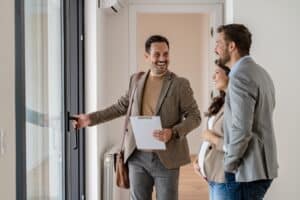 a realtor showing an expecting couple a home in the san diego area