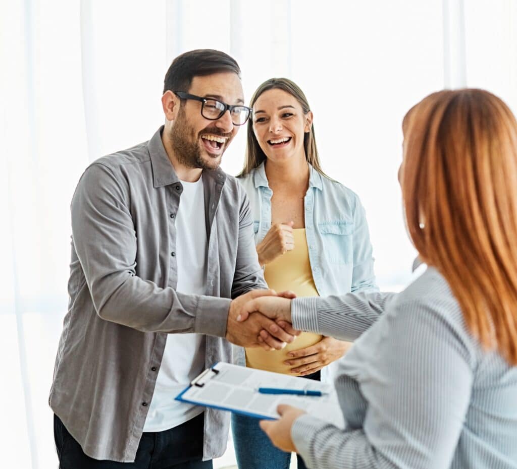Couple smiling after signing their lease agreement