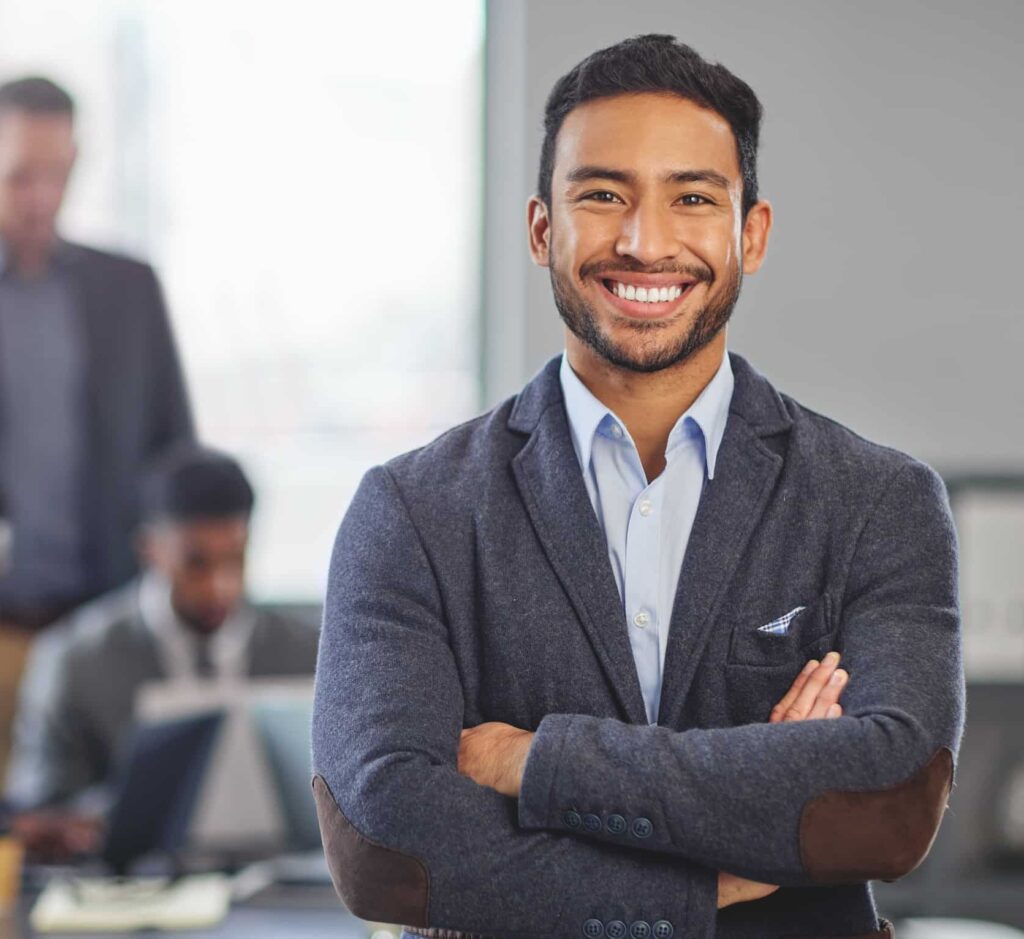 Real estate agent with arms folded and smiling
