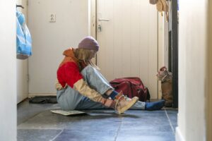 girl putting on shoes in a house